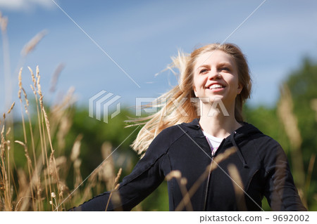 Young and happy girl in the field 9692002