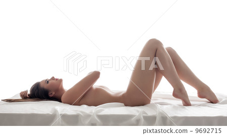 Curvy slim model posing lying naked in bed 9692715