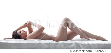 Sexy young brunette posing nude, lying in studio 9692716