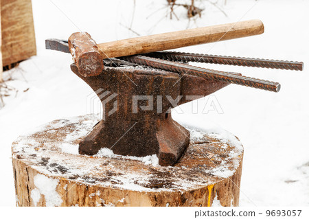 anvil with blacksmith tongs hammer in smithy 9693057