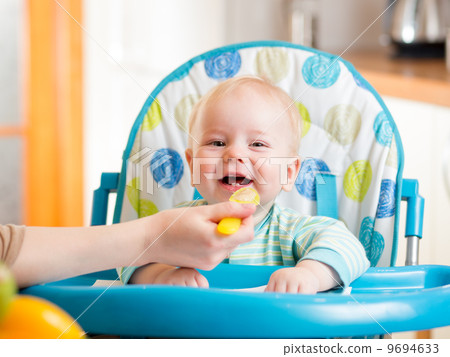 mother spoon feeding baby boy mother spoon feeding baby boy 9694633