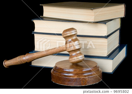 Wood gavel and books on a black background 9695802