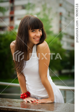 Pretty smiling girl with red beads 9696518