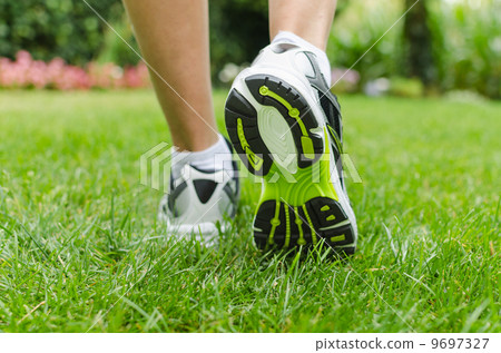 Woman running on grass Woman running on grass 9697327