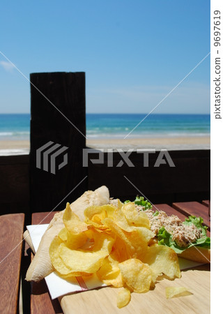 Tuna sandwich with beach front 9697619