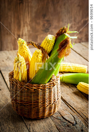 Fresh Corn in a Basket on the wooden table 9699654