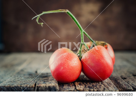 Red Tomatoes on the wooden backgroun Red Tomatoes on the wooden backgroun 9699680