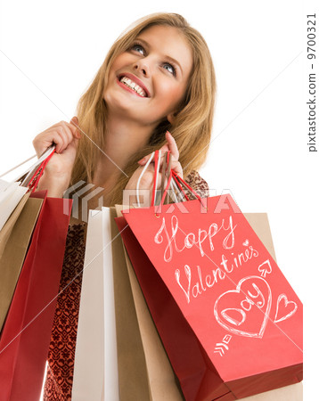 Shopping woman holding shopping bags looking upwards Shopping woman holding shopping bags looking upwards 9700321