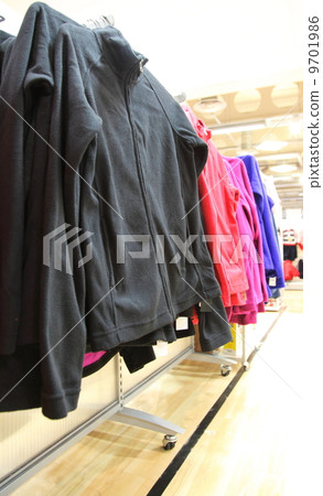 collection of women's clothes hanging on a rack collection of women's clothes hanging on a rack 9701986