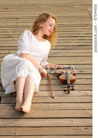 The blonde girl with a violin outdoor The blonde girl with a violin outdoor 9704408