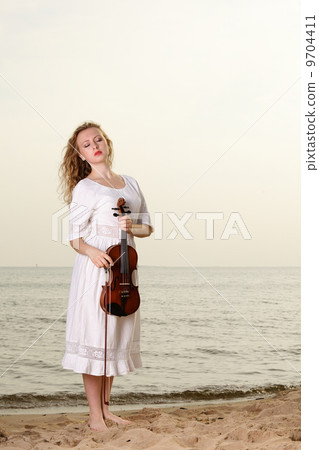 The blonde girl with a violin outdoor The blonde girl with a violin outdoor 9704411