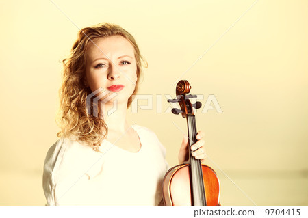 The blonde girl with a violin outdoor 9704415