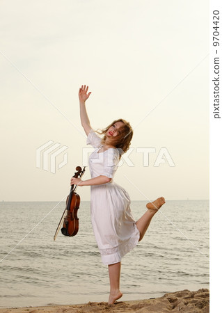 The blonde girl with a violin outdoor The blonde girl with a violin outdoor 9704420