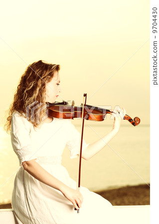 The blonde girl with a violin outdoor 9704430