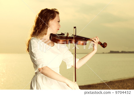 The blonde girl with a violin outdoor The blonde girl with a violin outdoor 9704432