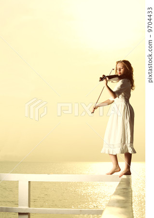 The blonde girl with a violin outdoor 9704433