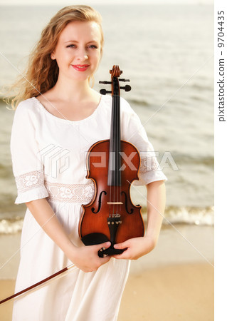 The blonde girl with a violin outdoor 9704435
