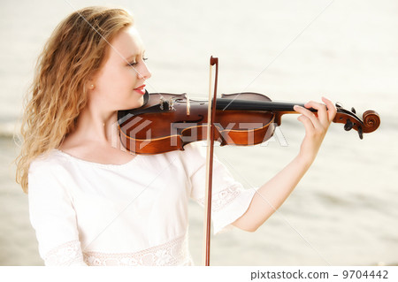 The blonde girl with a violin outdoor 9704442