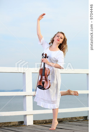 The blonde girl with a violin outdoor The blonde girl with a violin outdoor 9704446
