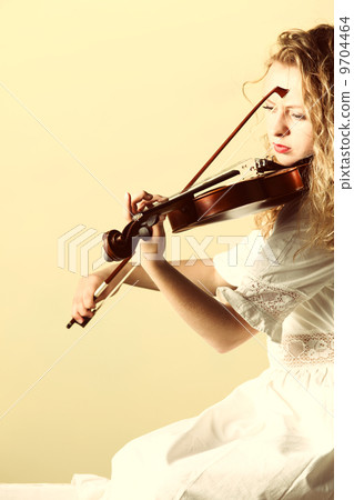 The blonde girl with a violin outdoor The blonde girl with a violin outdoor 9704464