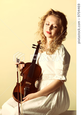 The blonde girl with a violin outdoor The blonde girl with a violin outdoor 9704469