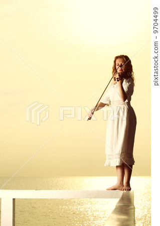 The blonde girl with a violin outdoor The blonde girl with a violin outdoor 9704499