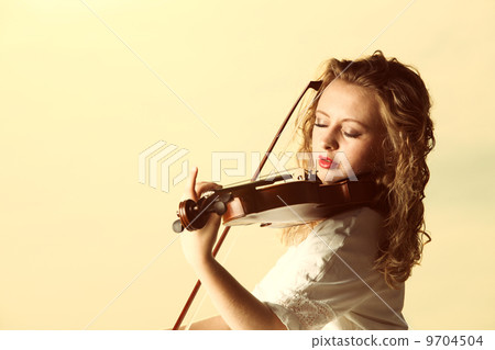 The blonde girl with a violin outdoor The blonde girl with a violin outdoor 9704504