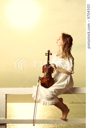 The blonde girl with a violin outdoor 9704505