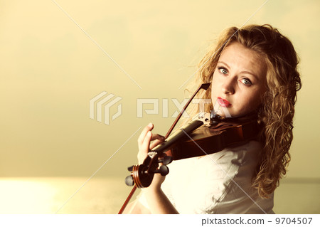 The blonde girl with a violin outdoor 9704507