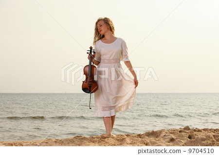 The blonde girl with a violin outdoor The blonde girl with a violin outdoor 9704510