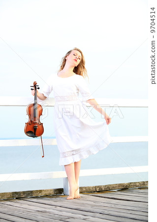 The blonde girl with a violin outdoor 9704514