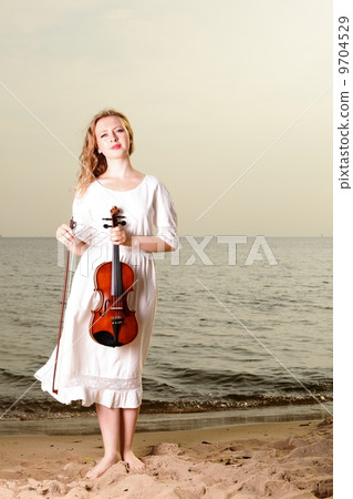 The blonde girl with a violin outdoor 9704529