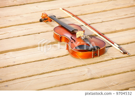 Violin on wooden pier. Music concept 9704532