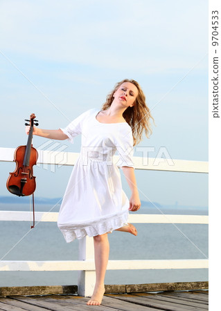 The blonde girl with a violin outdoor 9704533