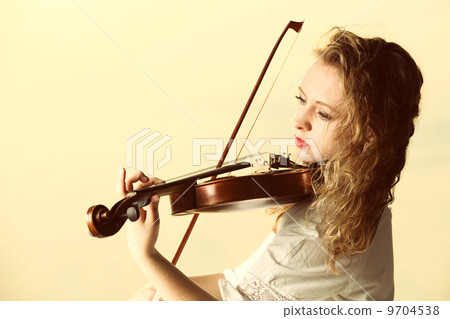 The blonde girl with a violin outdoor The blonde girl with a violin outdoor 9704538