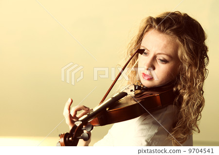 The blonde girl with a violin outdoor The blonde girl with a violin outdoor 9704541