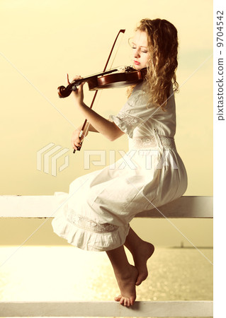 The blonde girl with a violin outdoor The blonde girl with a violin outdoor 9704542