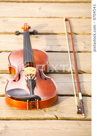 Violin on wooden pier. Music concept Violin on wooden pier. Music concept 9704543