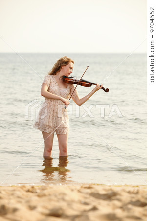 The blonde girl with a violin outdoor The blonde girl with a violin outdoor 9704552