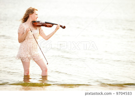 The blonde girl with a violin outdoor 9704583