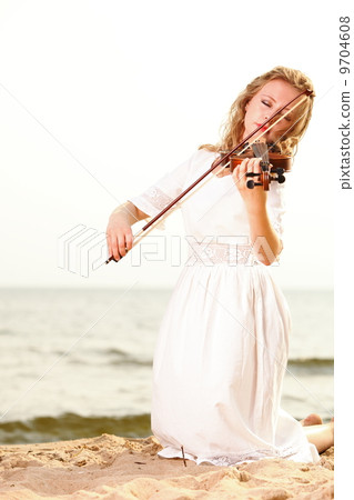 The blonde girl with a violin outdoor The blonde girl with a violin outdoor 9704608