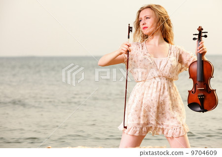 The blonde girl with a violin outdoor 9704609