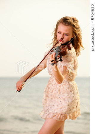 The blonde girl with a violin outdoor The blonde girl with a violin outdoor 9704620