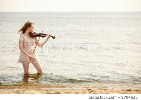 The blonde girl with a violin outdoor 9704623