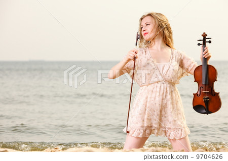 The blonde girl with a violin outdoor 9704626