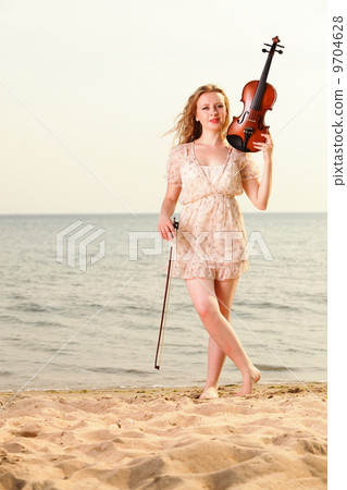 The blonde girl with a violin outdoor 9704628