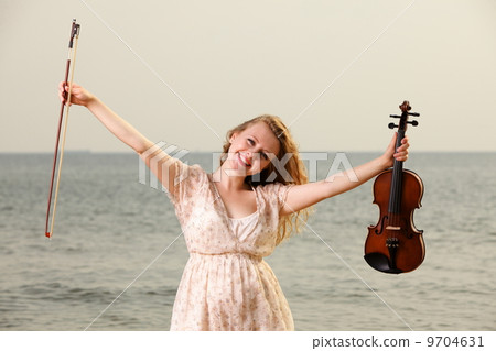Happy blonde girl with a violin outdoor Happy blonde girl with a violin outdoor 9704631