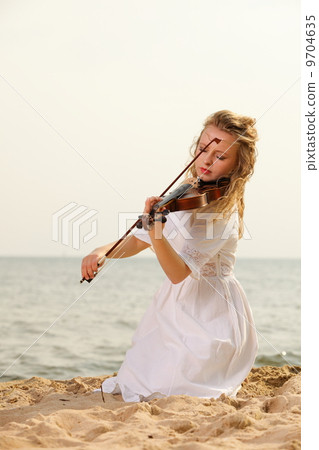 The blonde girl with a violin outdoor The blonde girl with a violin outdoor 9704635