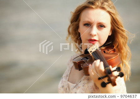 Portrait blonde girl with a violin outdoor 9704637