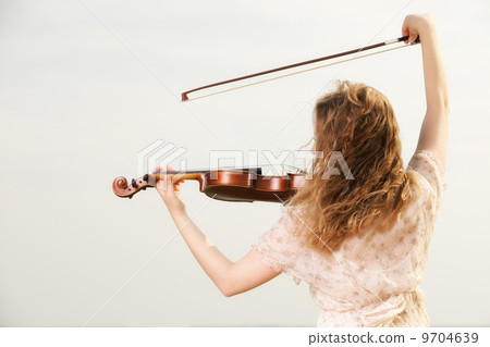 The blonde girl with a violin outdoor The blonde girl with a violin outdoor 9704639